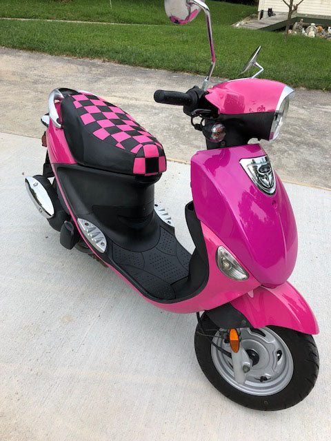Hot-pink Genuine Buddy with a matching pink-and-black checkered Cheeky Seats cover