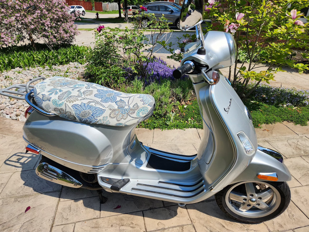 Vespa LX floral seat cover on white scooter