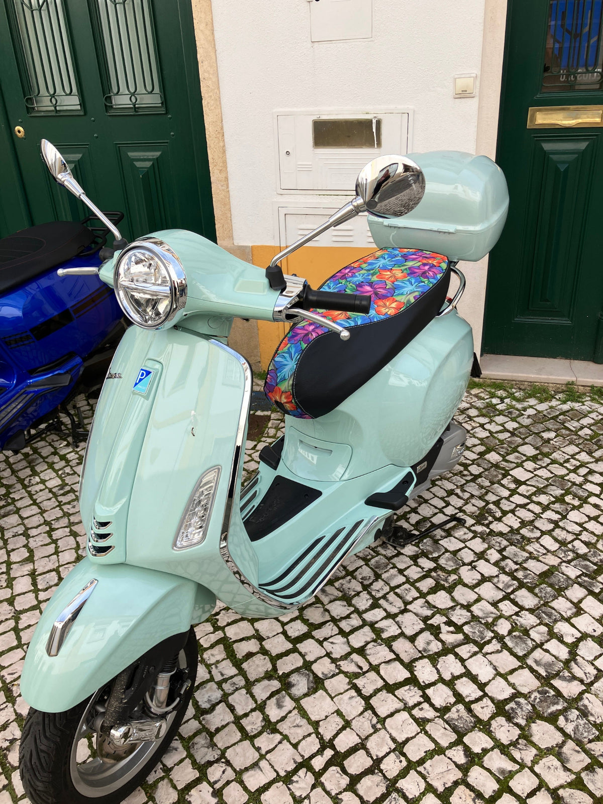 Hawaiian Flower seat cover fitted to a mint green Vespa, adding a bright tropical accent, handmade by Cheeky Seats.