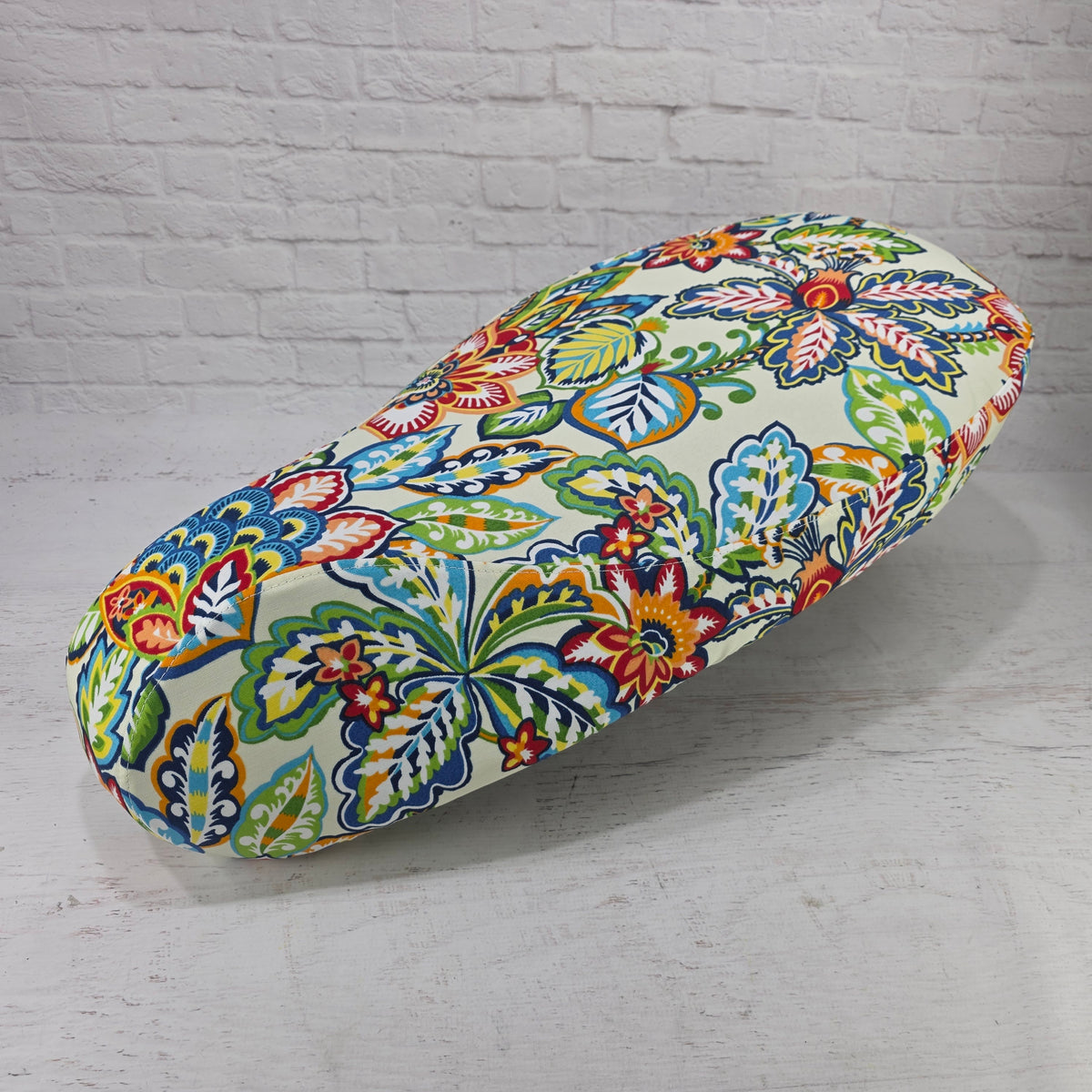 Angled view of the Folk Scandi Vespa seat cover showing the tailored panels and flowing botanical print, handmade by Cheeky Seats.