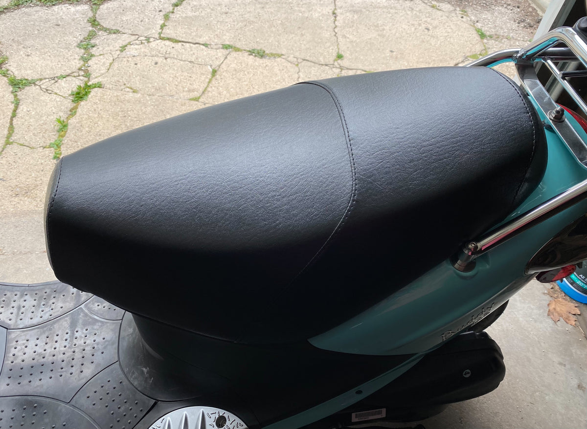 Classic black Cheeky Seats cover installed on a turquoise Genuine Buddy seat, overhead detail