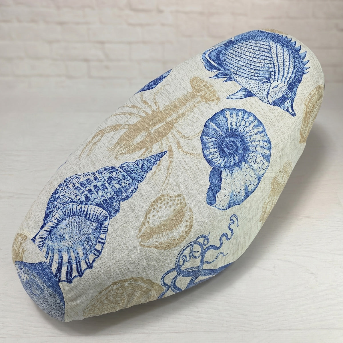 Detailed view of the Beachcomber scooter seat cover showing its tailored shape and seashore pattern, handmade by Cheeky Seats.