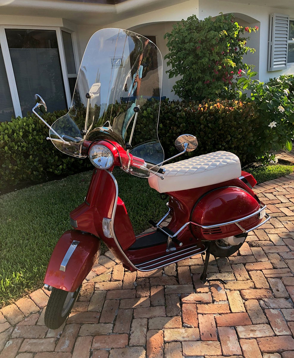 Red Genuine Stella with a large windshield and a cottage-white diamond-stitched seat cover handmade by Cheeky Seats
