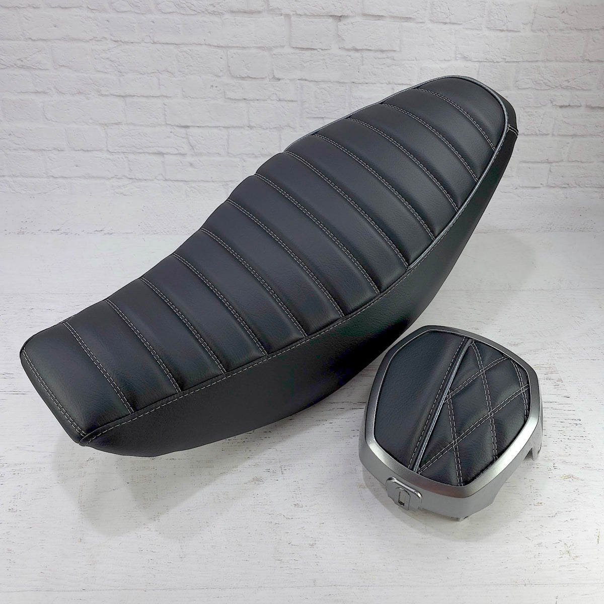 Honda Navi black tuck-and-roll seat cover with silver stitching and piping