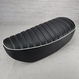 Black tuck-and-roll Honda DAX 125 seat cover with crisp white double stitching and white piping, handmade by Cheeky Seats