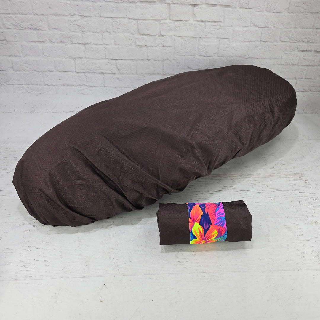 Brown honeycomb Honda DAX 125 protective seat cover with a matching pouch and vivid tropical strap, by Cheeky Seats