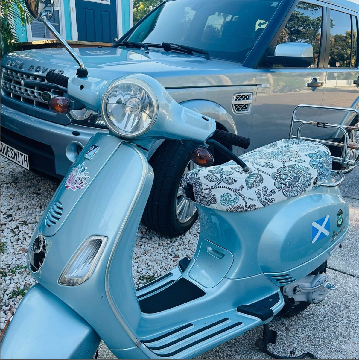 Vespa LX floral seat cover installed on scooter