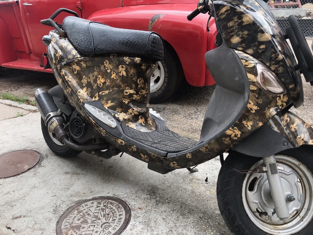 Custom black-and-gold Genuine Buddy with a black faux-crocodile Cheeky Seats cover, left-side detail