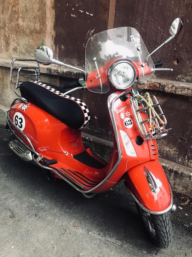 Vespa GTS checkered racing stripe seat cover on scooter